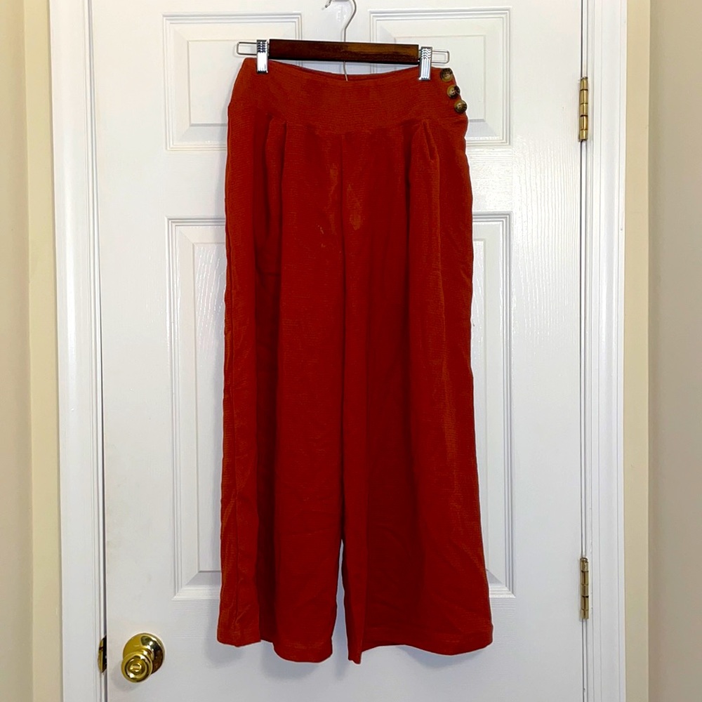 ASOS burnt orange flowy pants with buttons on side